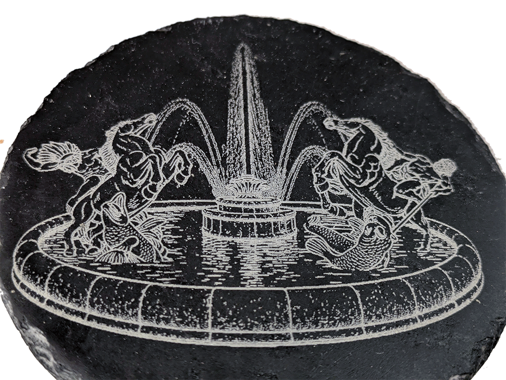 Detailed laser engraving on a round slate coaster