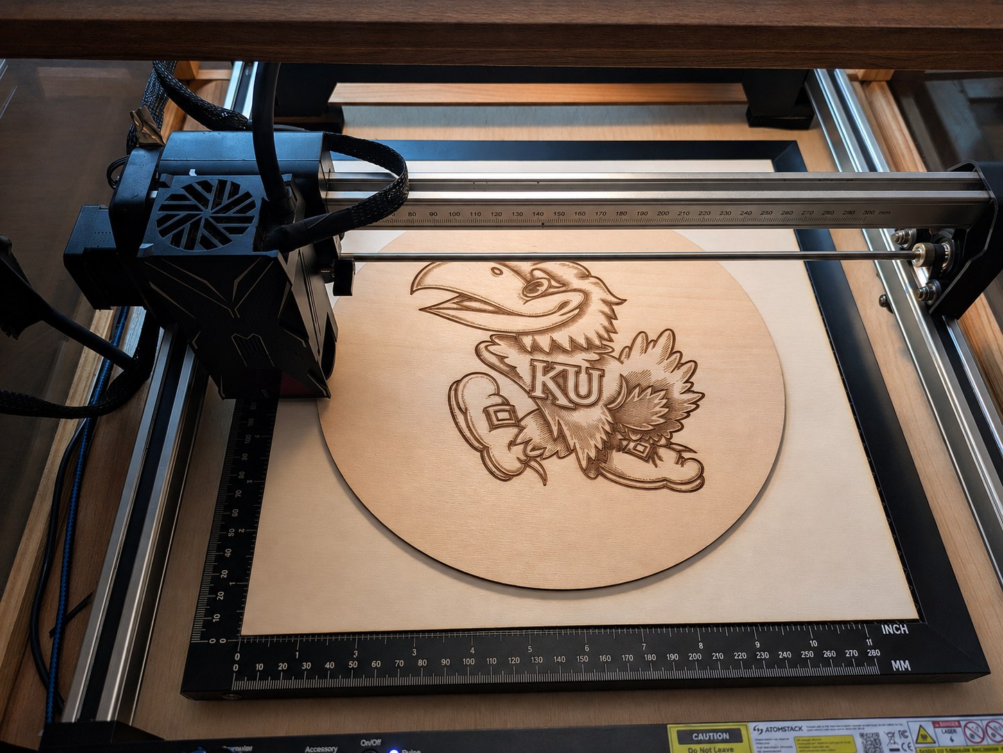Laser cutter engraving a detailed design