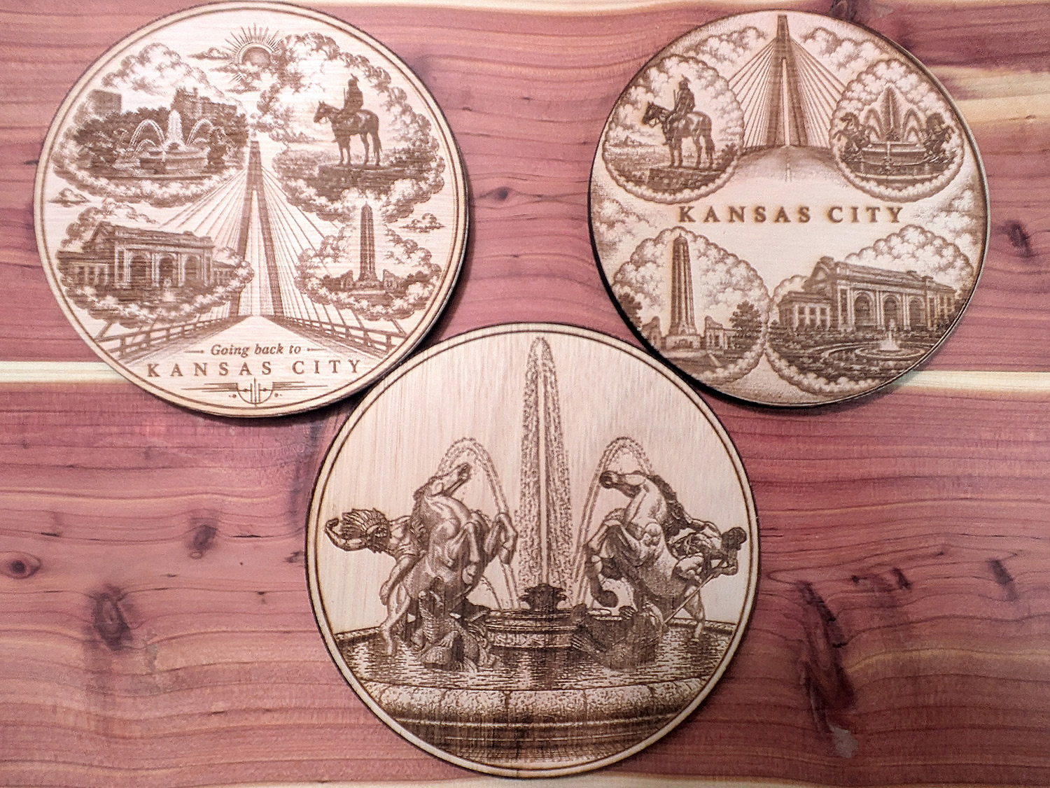 Round wooden coasters engraved with Kansas City landmark designs