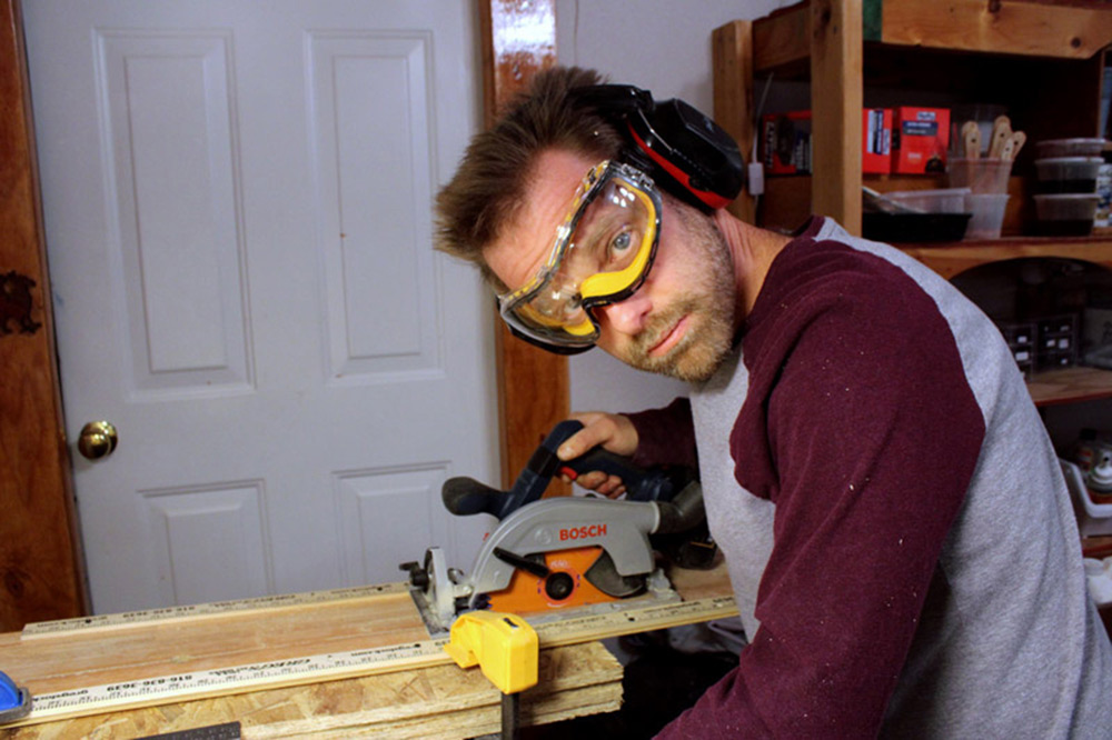 Cutting reclaimed wood with a circular saw in the workshop