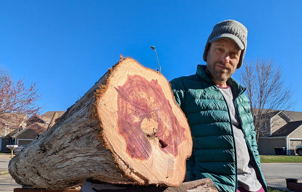 Holding a locally reclaimed cedar log